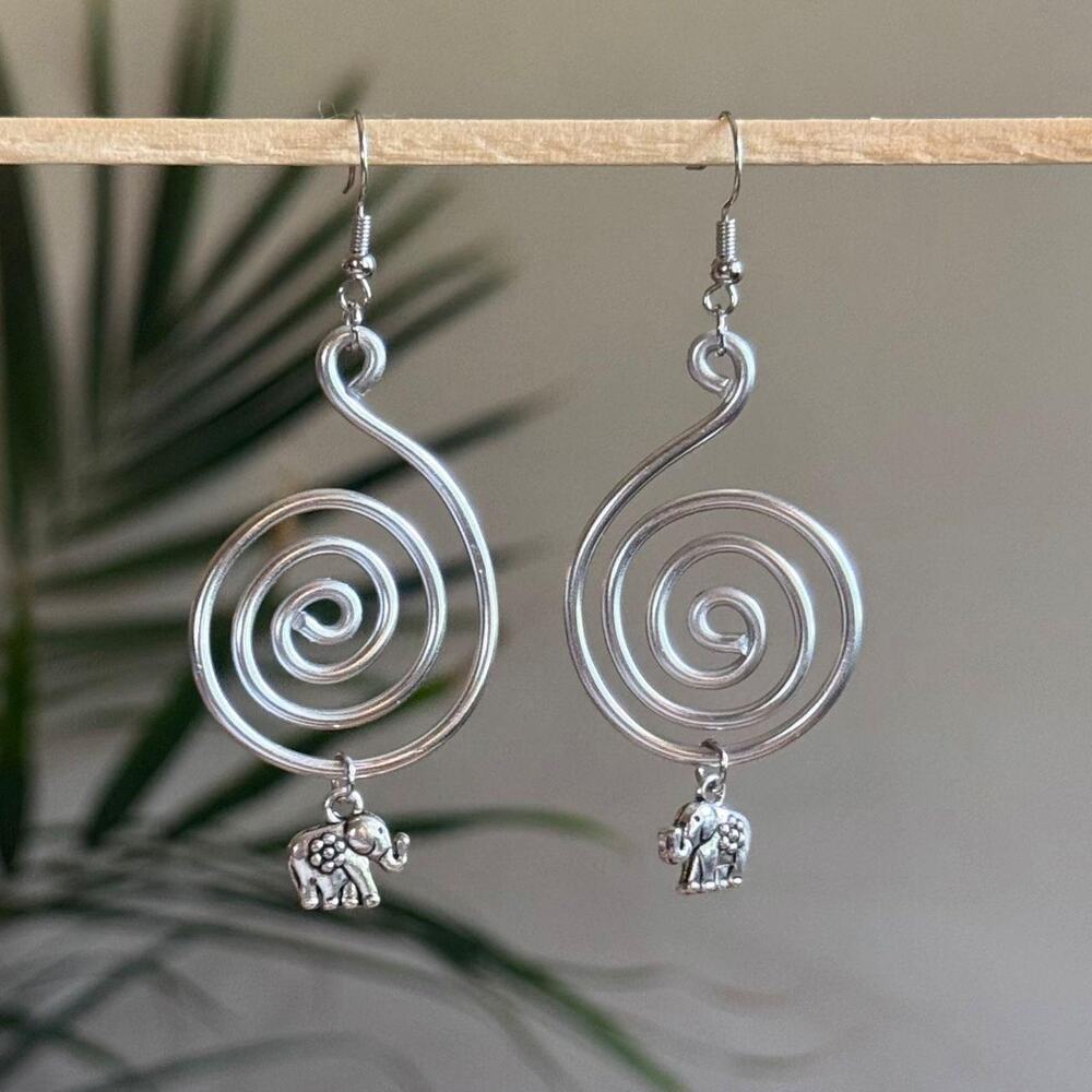 handmade silver wire spiral earrings with dangling silver elephant charms